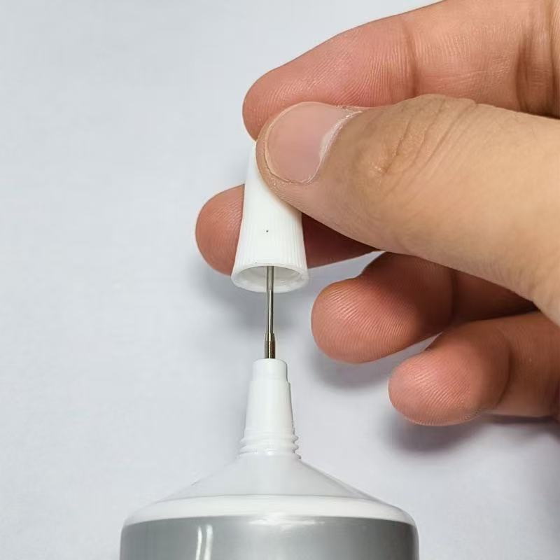 Cap pin and dispensing tip close-up